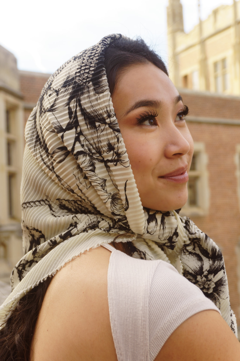 Portrait highlighting long eyelashes with a patterned headscarf